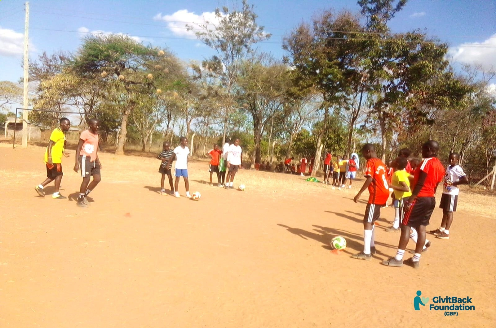 Coaches and players collaborating on the pitch!